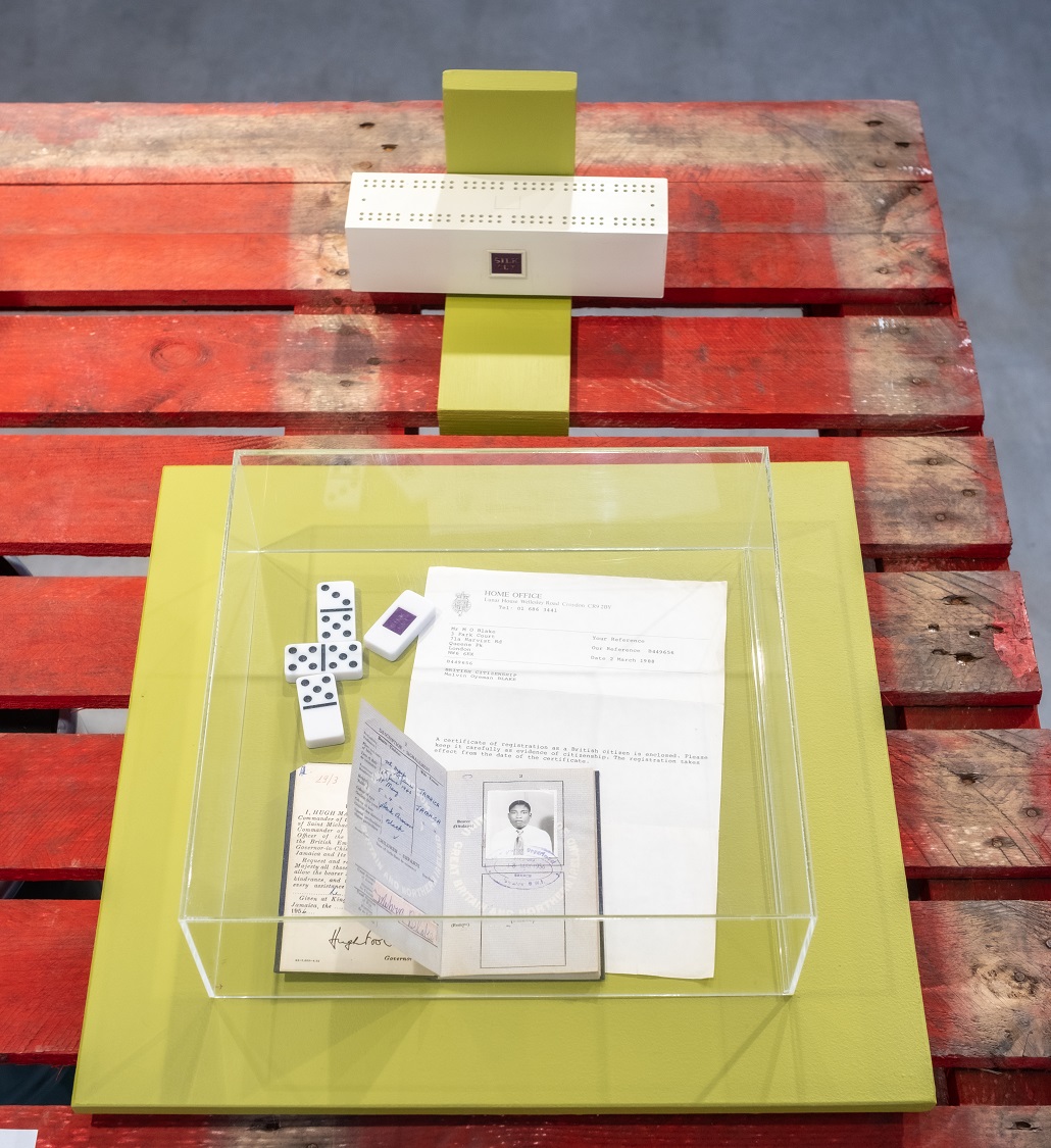 dominoes and a passport in a glass case